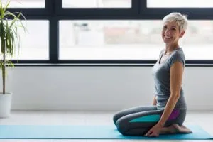 Woman sitting on pilates mat